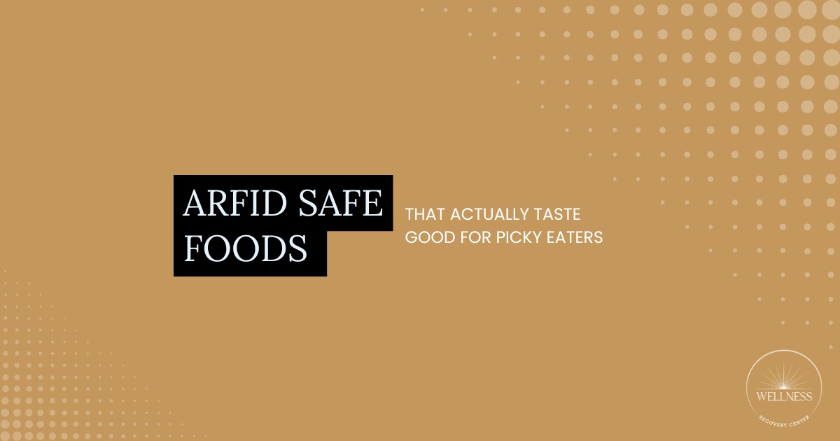Selection of ARFID safe foods like plain pasta, rice, bread, and simple snacks arranged on a table for picky eaters